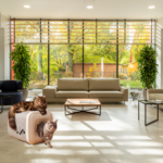 Large fluffy cat using a modern self-grooming house in a luxury living room